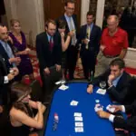 students having fun together in a group playing poker