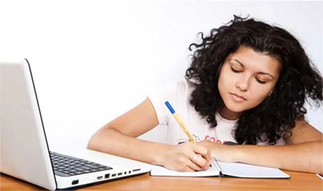 Student Working with Mac Laptop student books and educational material revision guide to get affordable