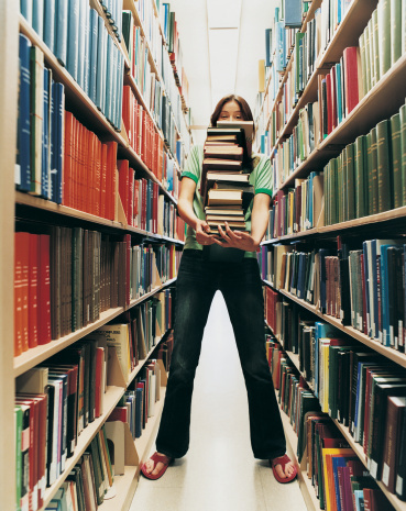 Female Student Holding a Pile of Books