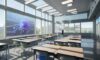 Students in a modern, high-tech classroom interacting with holographic 3D molecular models, illustrating the integration of advanced technology and education.