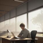 A focused college student studying calculus at a wooden desk in a sunlit, modern university library with textbooks and a laptop.