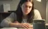 A frustrated and tired student studying under a warm desk lamp, highlighting a textbook to illustrate the struggle of passive learning.